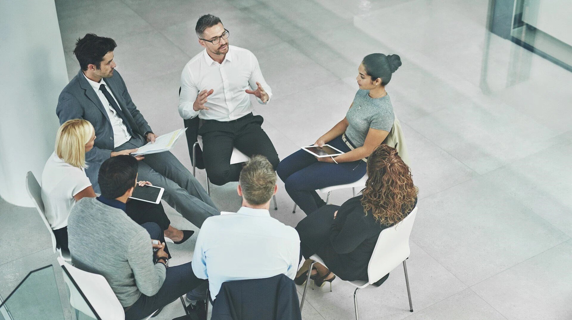 shot-of-a-group-of-coworkers-talking-together-whil-2023-11-27-04-58-11-utc-2